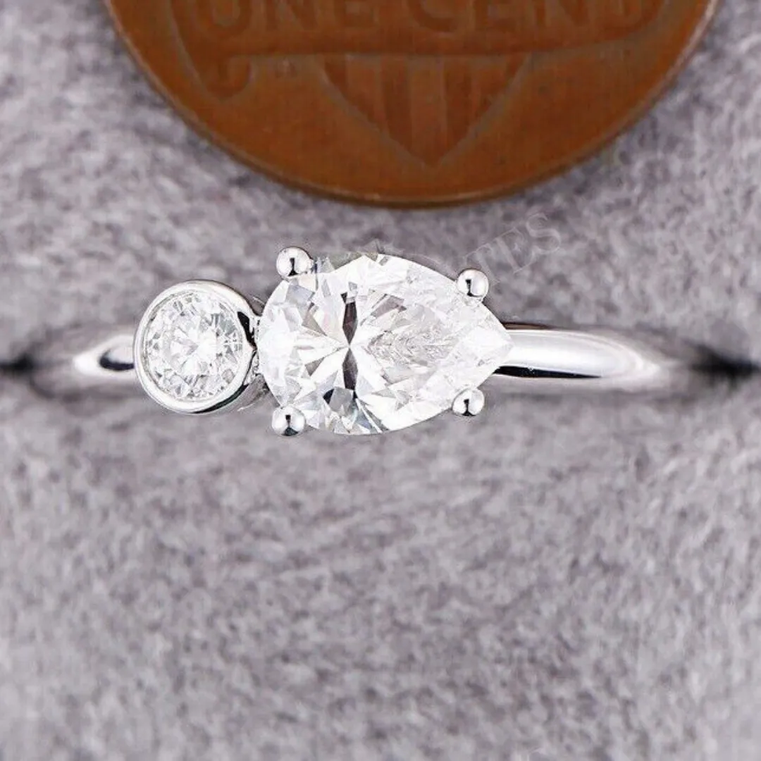 /public/photos/live/East West Pear With Round Cut 2 Stone Moissanite Ring 645 (1).webp
